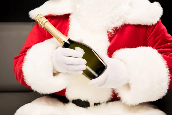 Santa Claus holding bottle of champagne — Stock Photo, Image