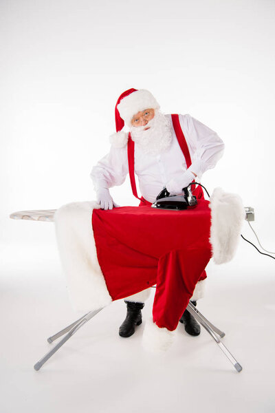 Santa Claus ironing coat
