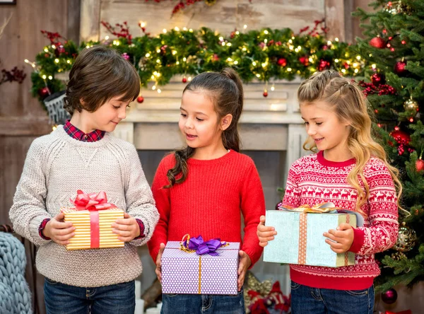 Happy children holding gift boxes — Stock Photo, Image