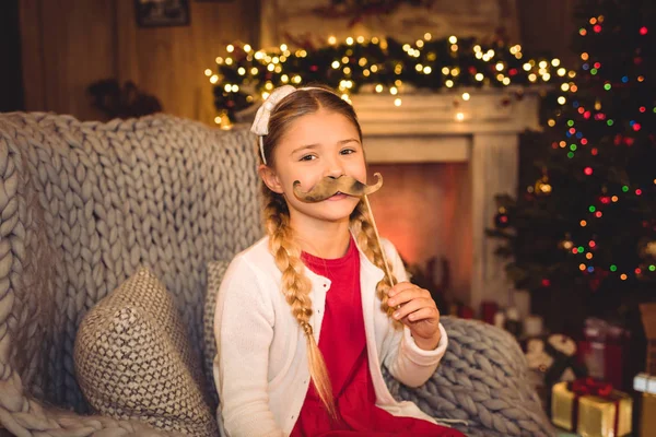 Girl holding moustache on stick — Stock Photo, Image