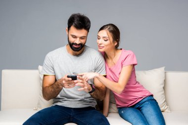 Couple using smartphones  clipart