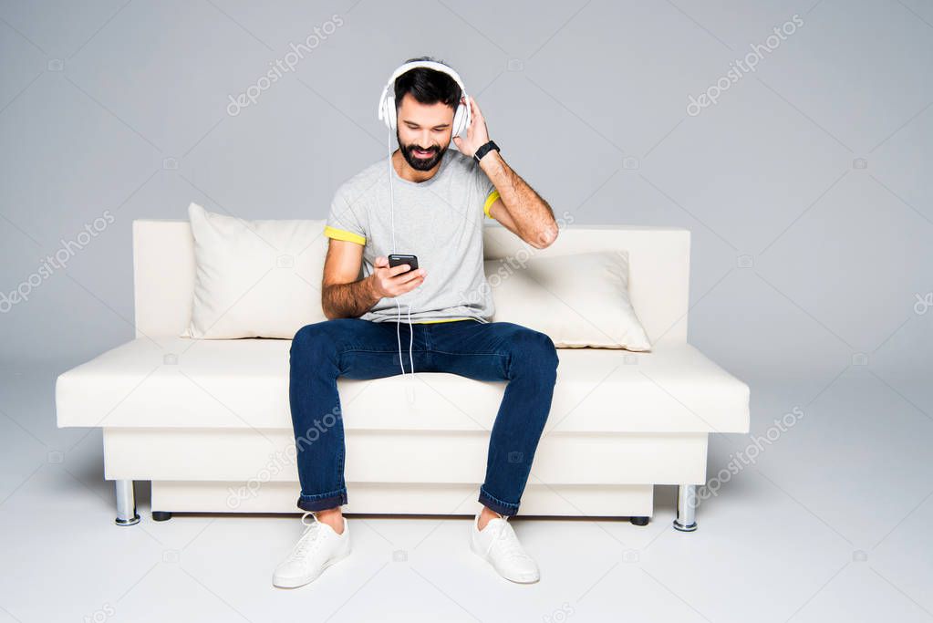 Bearded man in white headphones