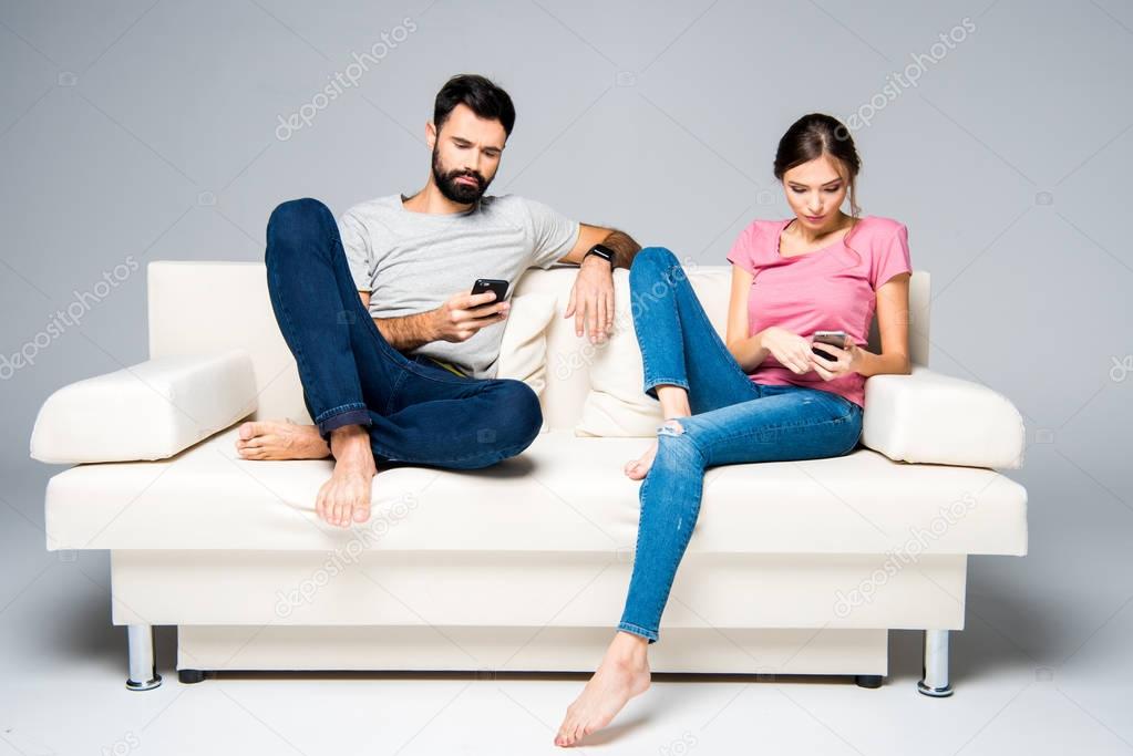 Couple using smartphones 