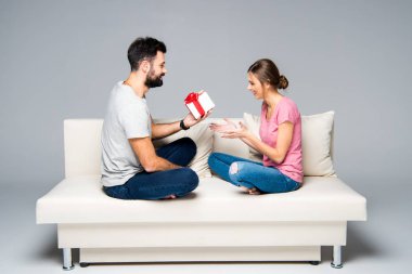 Man giving gift box to woman clipart