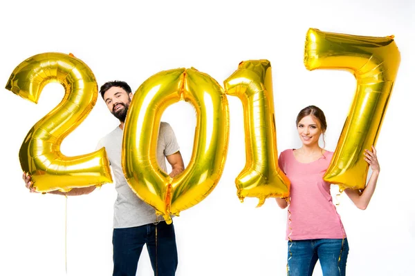 Couple holding golden balloons — Stock Photo, Image