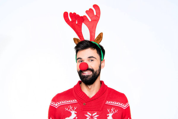 Smiling man in antlers and red nose