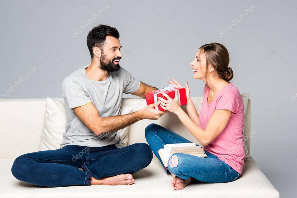Man giving gift box to woman