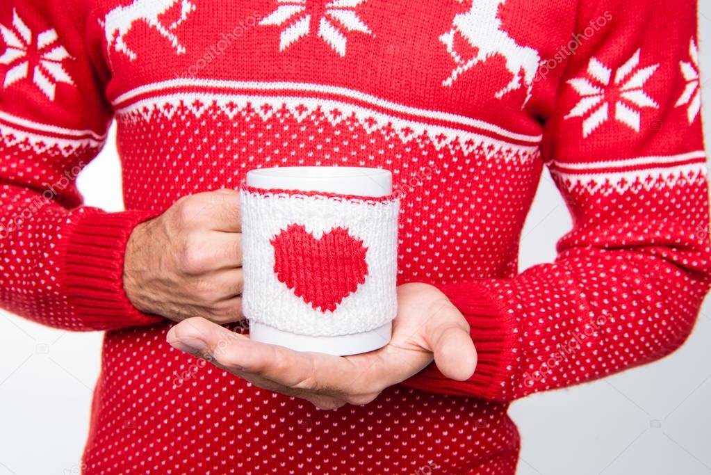 Man holding cup with hot drink 