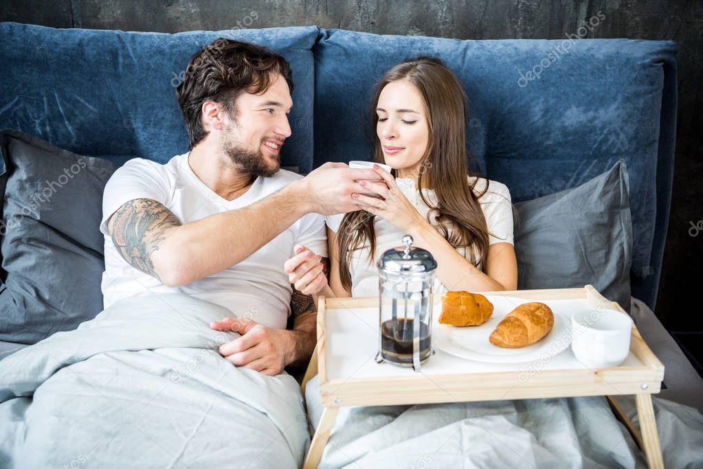 Couple has breakfast in bed