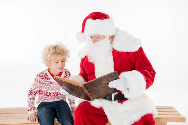 Santa Claus reading book with kid — Stock Photo