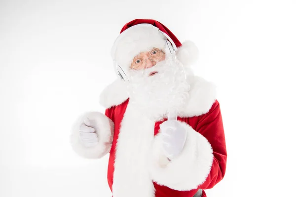 Santa Claus listening music with headphones — Stock Photo