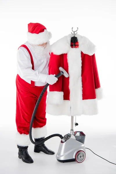 Santa Claus cleaning coat — Stock Photo