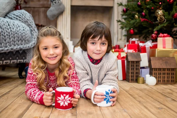 Happy kids lying on floor — Stock Photo