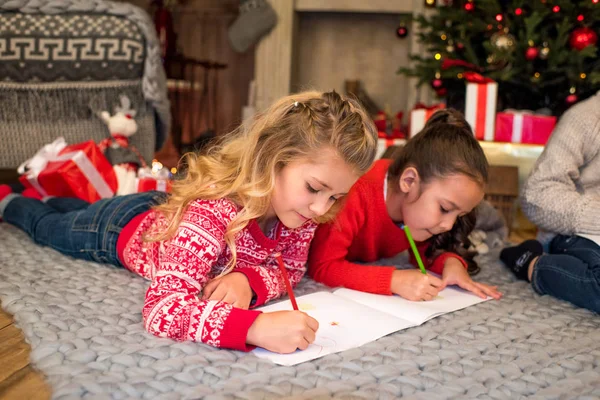 Kids lying drawing picture — Stock Photo