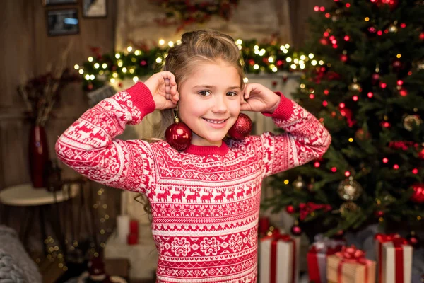 Happy kid with Christmas baubles — Stock Photo