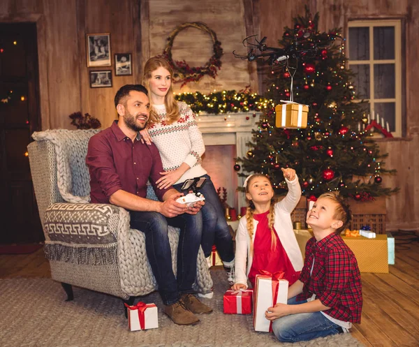 Happy family using hexacopter drone — Stock Photo