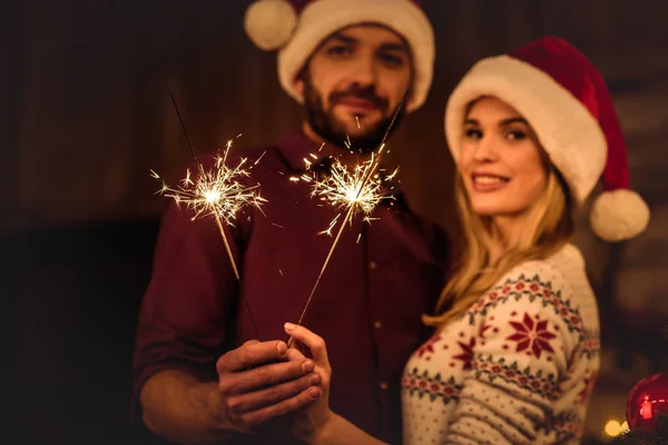 Couple holding sparklers — Stock Photo