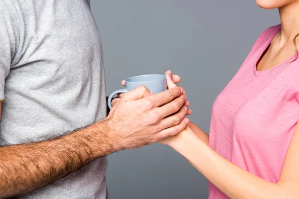 Couple holding cup — Stock Photo