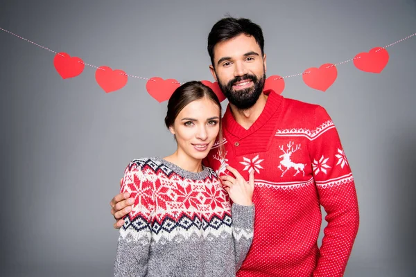 Smiling couple in knitted sweaters — Stock Photo
