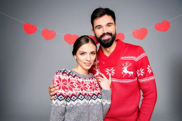 Pareja sonriente en suéteres de punto — Stock Photo