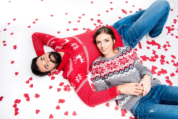 Couple lying with hearts — Stock Photo
