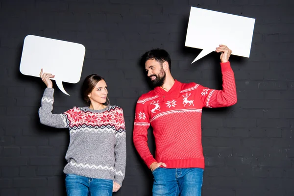 Attractive couple with speech bubbles — Stock Photo