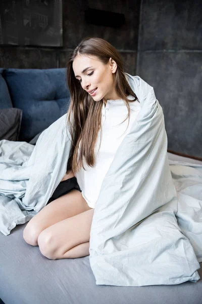 Young woman on bed — Stock Photo