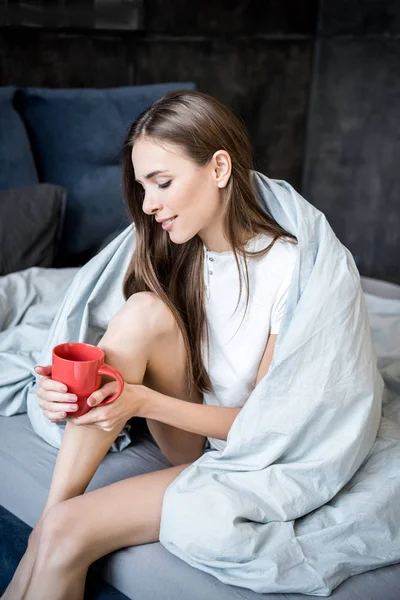 Woman holding cup of tea — Stock Photo