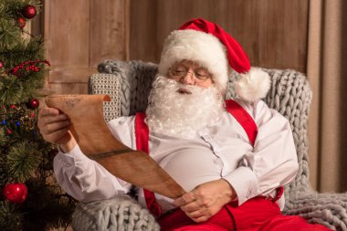 Santa Claus reading wishlist  clipart