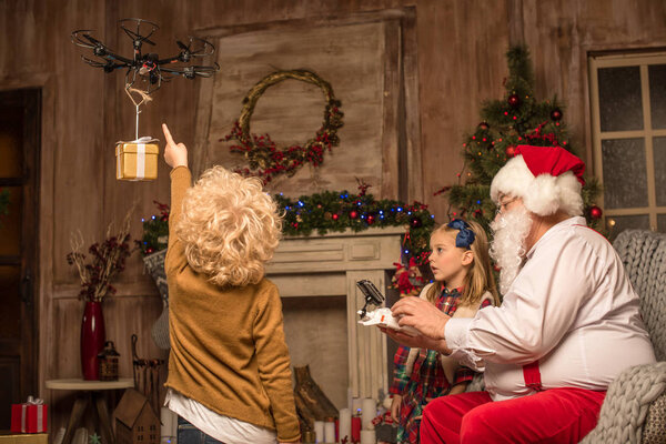 Santa Claus with children using hexacopter drone  