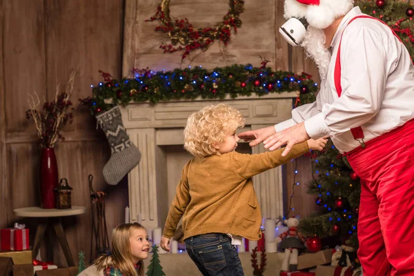 Santa Claus playing with children — Stock Photo, Image