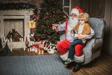 Santa with kid using hexacopter drone  clipart