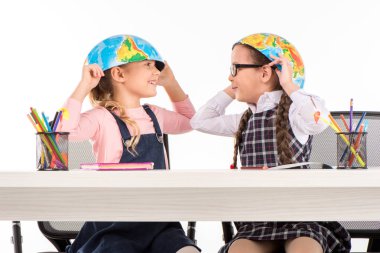 Schoolgirls with halves of globe on heads clipart
