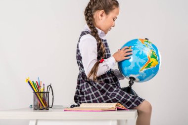 Schoolgirl using globe clipart