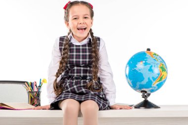 Happy schoolgirl sitting  with globe  clipart