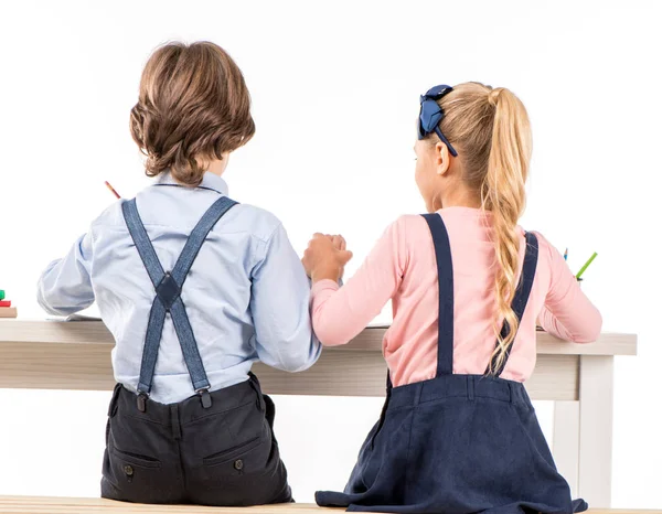 Classmates sitting at desk — Stock Photo, Image