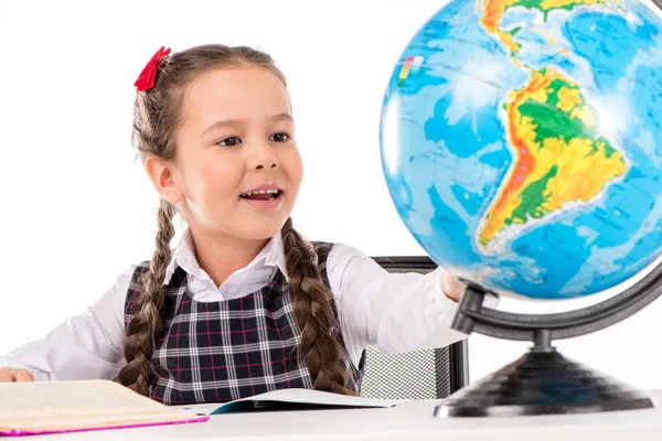 Schoolgirl looking for something on globe — Stock Photo, Image