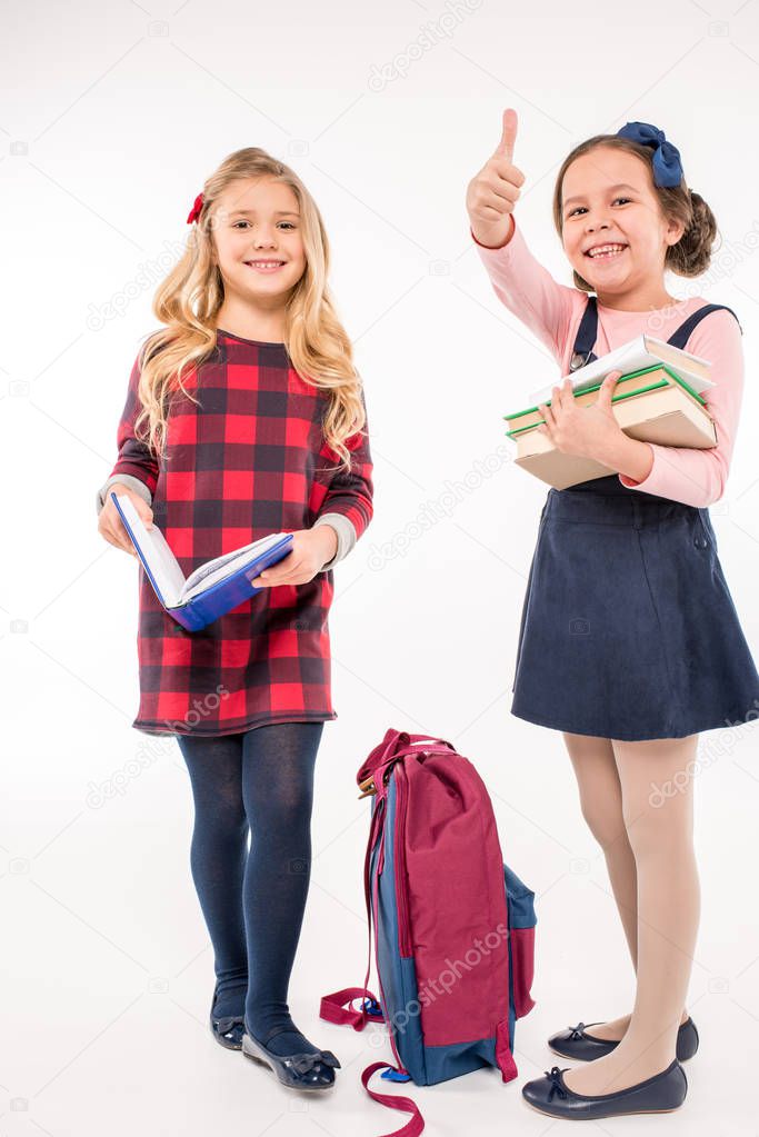 Schoolgirls with books gesturing