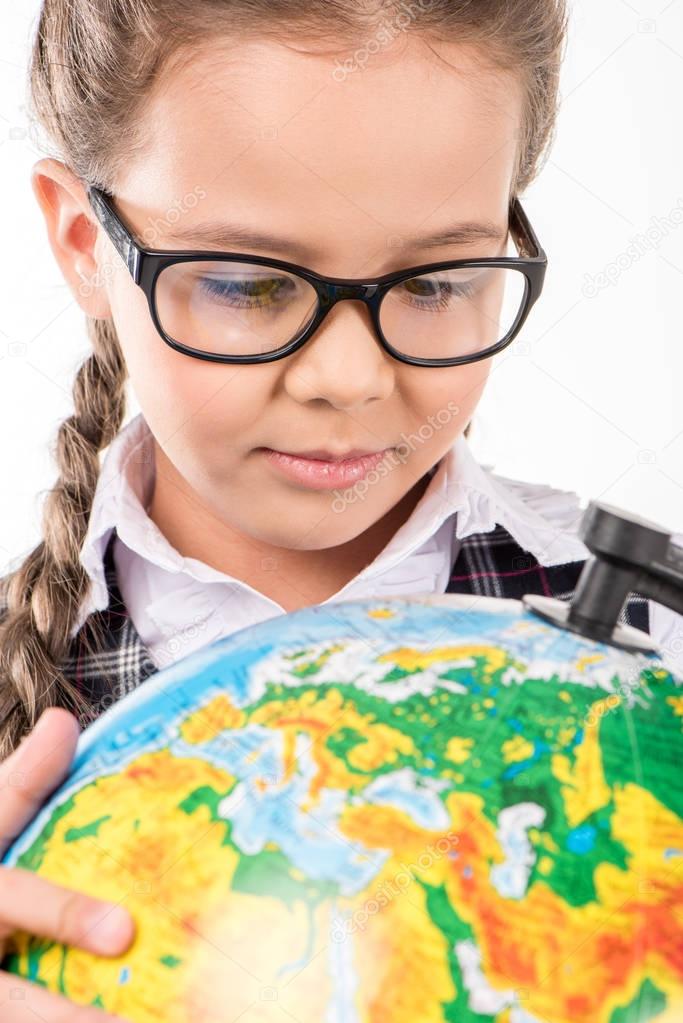 Schoolgirl looking at globe