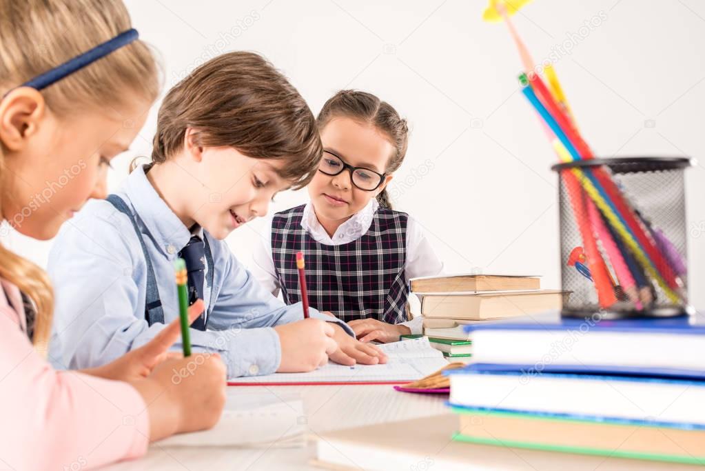 Children writing in notebooks 
