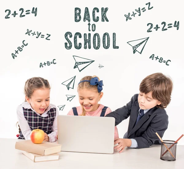 Schoolchildren using laptop — Stock Photo, Image