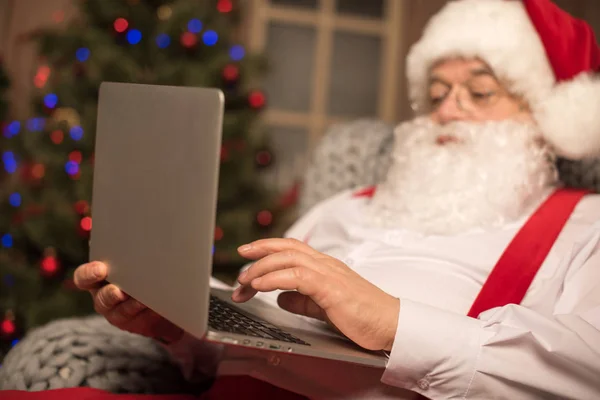 Santa Claus using laptop — Stock Photo