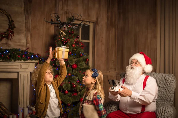 Santa Claus with children using hexacopter drone — Stock Photo