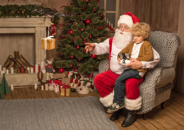 Santa with kid using hexacopter drone — Stock Photo