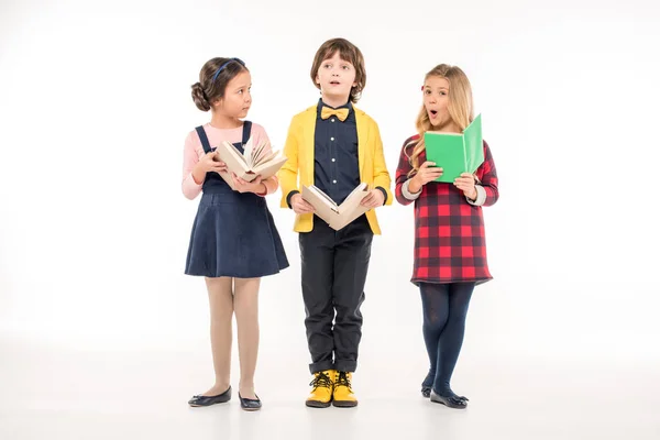 Schoolchildren standing with books — Stock Photo