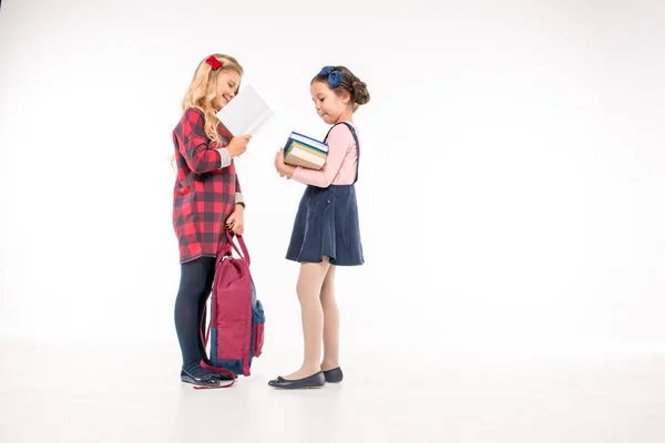 Smiling schoolgirls standing with books — Stock Photo