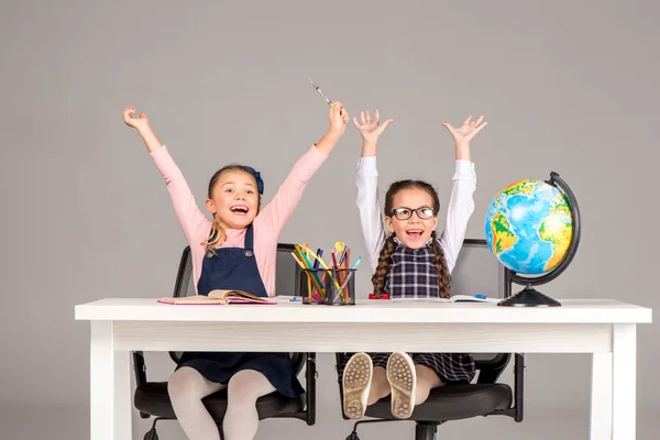 Happy schoolgirls during geography lesson — Stock Photo