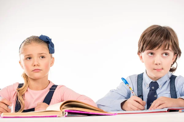 Schoolchildren studying with serious expression — Stock Photo