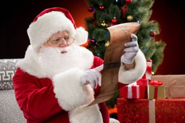 Santa Claus reading wishlist clipart