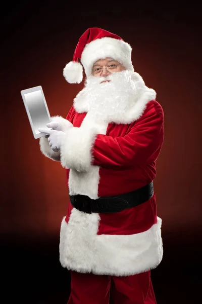 Санта-Клаус с цифровым планшетом — стоковое фото